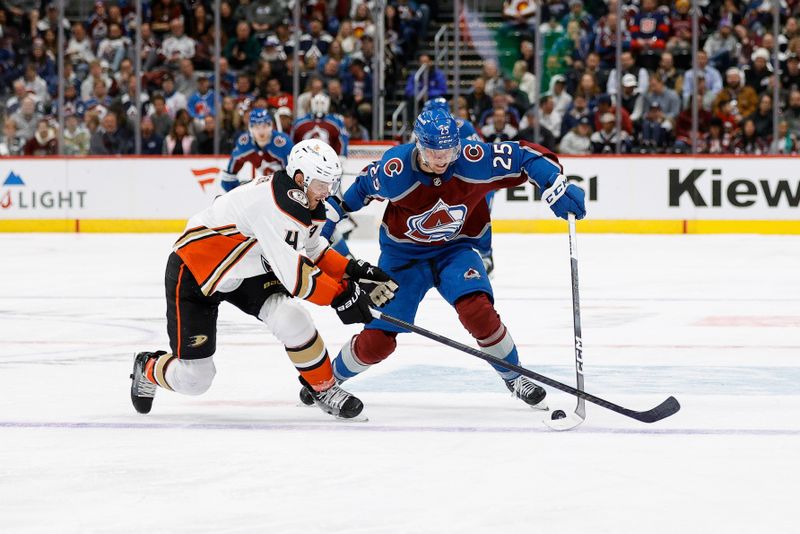 Dec 5, 2023; Denver, Colorado, USA; Colorado Avalanche right wing Logan O'Connor (25) controls the puck under pressure from Anaheim Ducks defenseman Cam Fowler (4) in the second period at Ball Arena. Mandatory Credit: Isaiah J. Downing-USA TODAY Sports