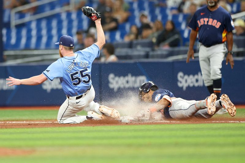 Aug 12, 2024; St. Petersburg, Florida, USA; Tampa Bay Rays pitcher Richard Lovelady (55) tries to beat Houston Astros shortstop Jeremy Pena (3) to first base in the seventh inning at Tropicana Field. Mandatory Credit: Nathan Ray Seebeck-USA TODAY Sports