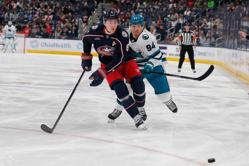 Mar 16, 2024; Columbus, Ohio, USA; Columbus Blue Jackets defenseman Zach Werenski (8) and San Jose Sharks right wing Alexander Barabanov (94) skate after a loose puck during the first period at Nationwide Arena. Mandatory Credit: Russell LaBounty-USA TODAY Sports