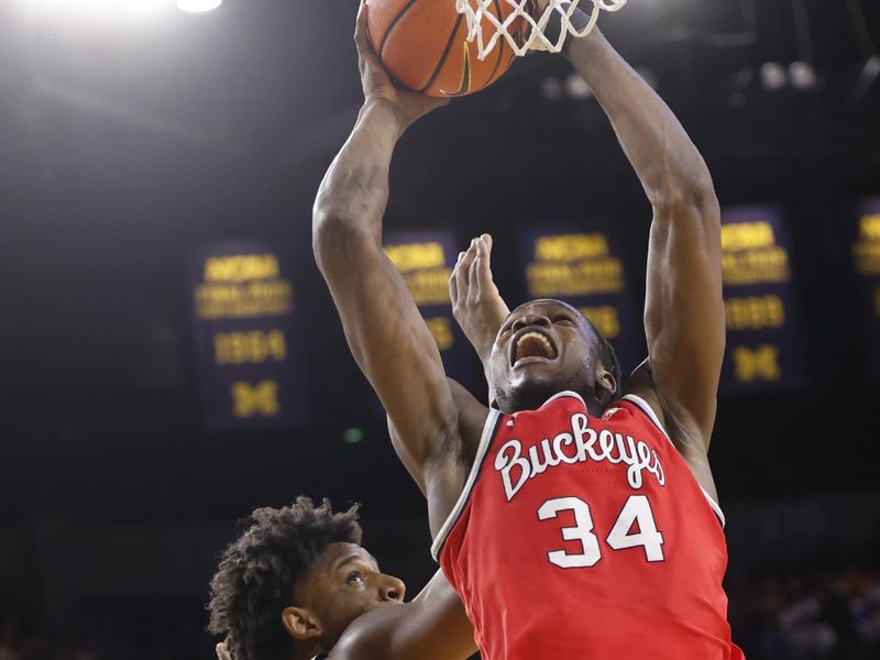 Jan 15, 2024; Ann Arbor, Michigan, USA; Ohio State Buckeyes center Felix Okpara (34) shoots as Michigan Wolverines forward Tarris Reed Jr. (32) defends in the second half at Crisler Center. Mandatory Credit: Rick Osentoski-USA TODAY Sports