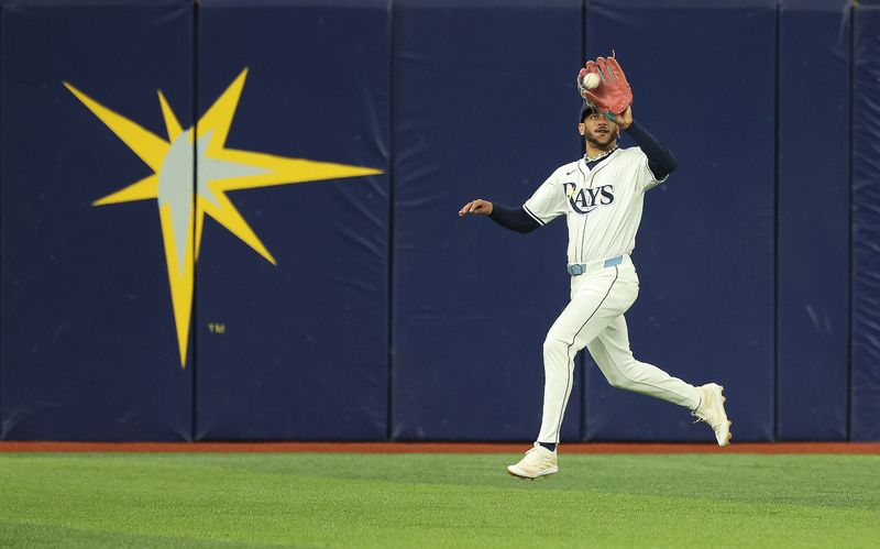 Sep 17, 2024; St. Petersburg, Florida, USA; Tampa Bay Rays outfielder Jose Siri (22) catches a fly ball against the Boston Red Sox during the second inning at Tropicana Field. Mandatory Credit: Kim Klement Neitzel-Imagn Images