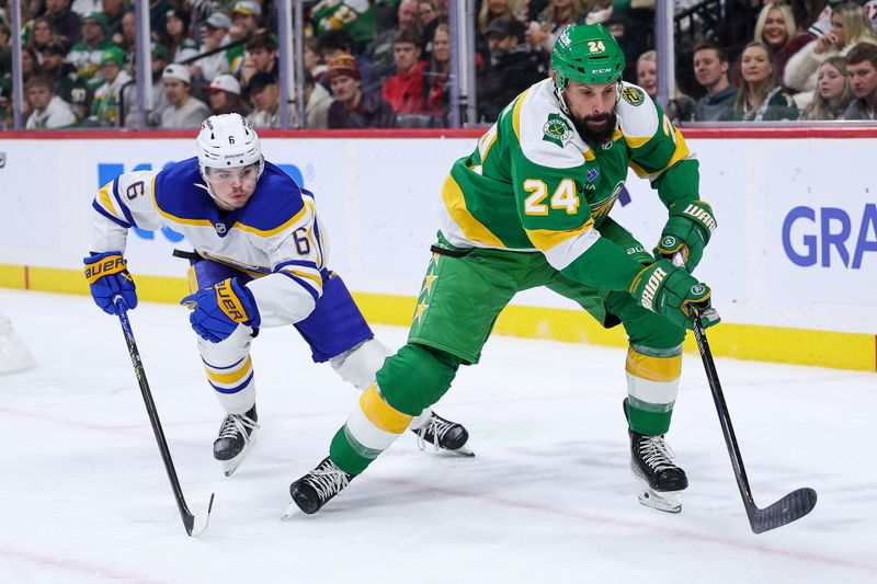 Nov 29, 2025; Saint Paul, Minnesota, USA; Minnesota Wild defenseman Zach Bogosian (24) and Buffalo Sabres left wing Zach Benson (6) compete for the puck during the second period at Grand Casino Arena. Mandatory Credit: Matt Krohn-Imagn Images