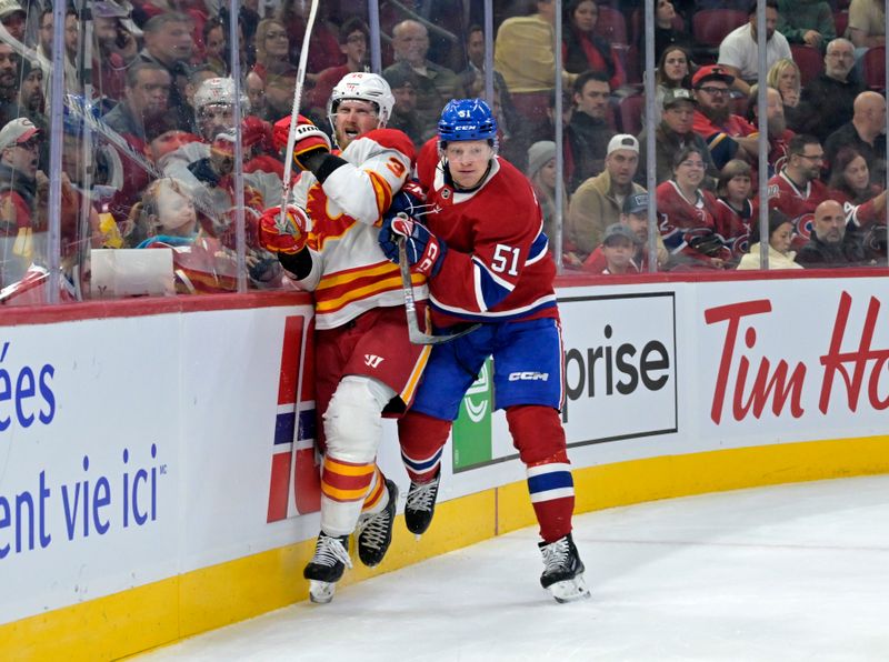 Nov 5, 2024; Montreal, Quebec, CAN; Montreal Canadiens forward Emil Heineman (51) checks Calgary Flames forward Anthony Mantha (39) during the first period at the Bell Centre. Mandatory Credit: Eric Bolte-Imagn Images