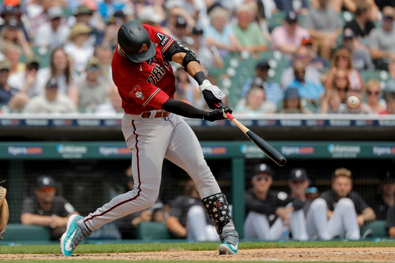 Jun 10, 2023; Detroit, Michigan, USA;  Arizona Diamondbacks designated hitter Lourdes Gurriel Jr. (12) hits a three-run home run in the fifth inning against the Detroit Tigers at Comerica Park. Mandatory Credit: Rick Osentoski-USA TODAY Sports