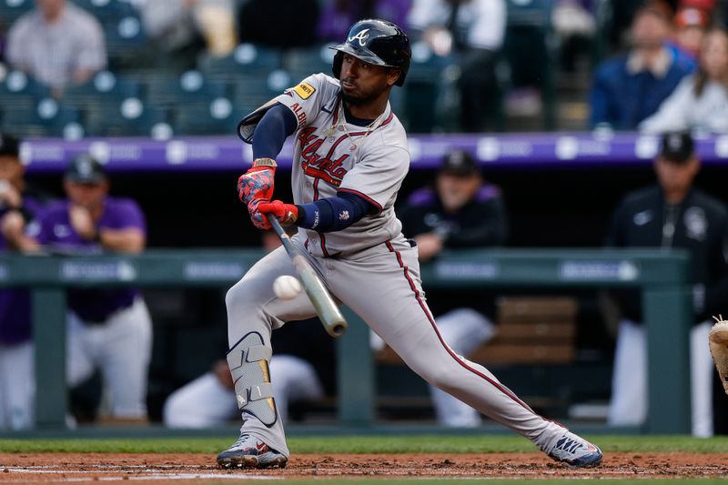 Apr 28, 2025; Denver, Colorado, USA; Atlanta Braves second baseman Ozzie Albies (1) hits a single in the second inning against the Colorado Rockies at Coors Field. Mandatory Credit: Isaiah J. Downing-Imagn Images