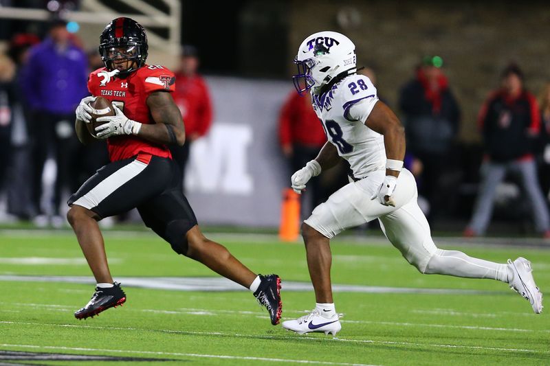 Nov 2, 2023; Lubbock, Texas, USA; Texas Tech Red Raiders running back Tahj Brooks (28) rushes against Texas Christian Horned Frogs defensive back Millard Bradford (28) in the second half at Jones AT&T Stadium and Cody Campbell Field. Mandatory Credit: Michael C. Johnson-USA TODAY Sports