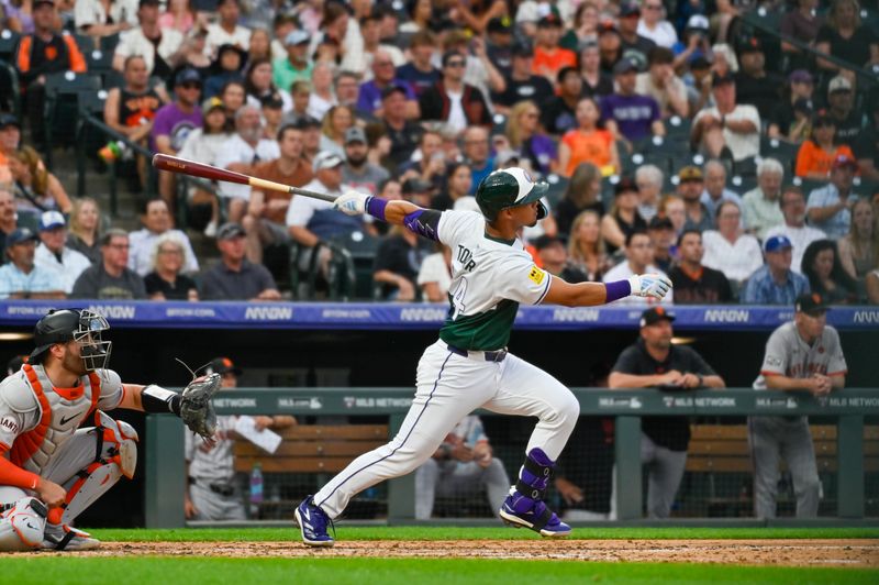 Jul 20, 2024; Denver, Colorado, USA; Colorado Rockies shortstop Ezequiel Tovar (14) hits a home run against the San Francisco Giants in the fifth inning at Coors Field. Mandatory Credit: John Leyba-USA TODAY Sports