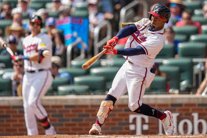 Sep 20, 2023; Cumberland, Georgia, USA; Atlanta Braves second baseman Ozzie Albies (1) hits a double against the Philadelphia Phillies during the eighth inning at Truist Park. Mandatory Credit: Dale Zanine-USA TODAY Sports