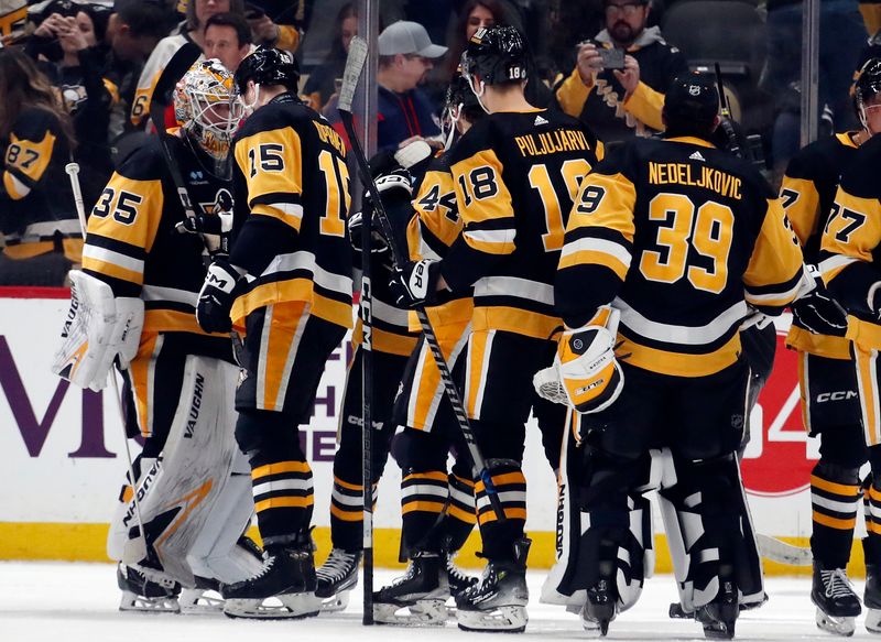 Mar 5, 2024; Pittsburgh, Pennsylvania, USA; The Pittsburgh Penguins celebrate after defeating the Columbus Blue Jackets at PPG Paints Arena. The Penguins won 5-3. Mandatory Credit: Charles LeClaire-USA TODAY Sports