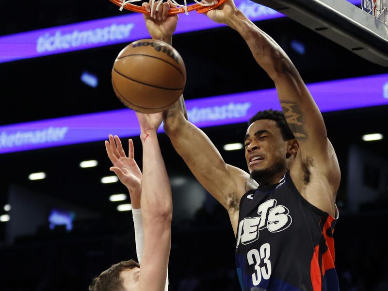 NEW YORK, NEW YORK - JANUARY 29: Nic Claxton #33 of the Brooklyn Nets dunks as Walker Kessler #24 of the Utah Jazz defends during the second half at Barclays Center on January 29, 2024 in the Brooklyn borough of New York City. The Nets won 147-114. NOTE TO USER: User expressly acknowledges and agrees that, by downloading and/or using this Photograph, user is consenting to the terms and conditions of the Getty Images License Agreement. (Photo by Sarah Stier/Getty Images)