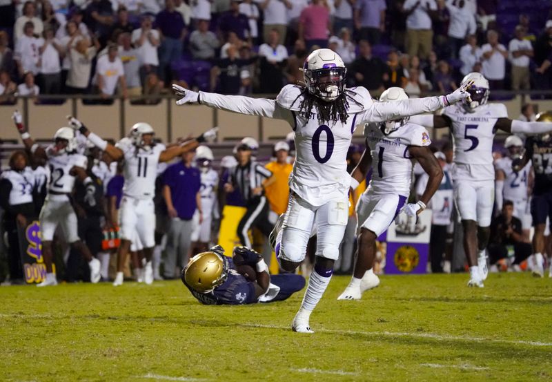 Sep 24, 2022; Greenville, North Carolina, USA;  East Carolina Pirates cornerback Juan Powell (0) celebrates stopping the pass attempt to Navy Midshipmen wide receiver Mark Walker (80) during the second half during the overtime at Dowdy-Ficklen Stadium. Mandatory Credit: James Guillory-USA TODAY Sports