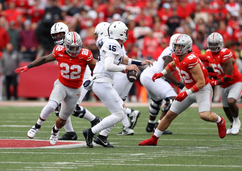 Oct 21, 2023; Columbus, Ohio, USA;  Penn State Nittany Lions quarterback Drew Allar (15) drops back against the pash rush of Ohio State Buckeyes linebacker Steele Chambers (22) and defensive end Caden Curry (92) during the fourth quarter against the Penn State Nittany Lions at Ohio Stadium. Mandatory Credit: Joseph Maiorana-USA TODAY Sports