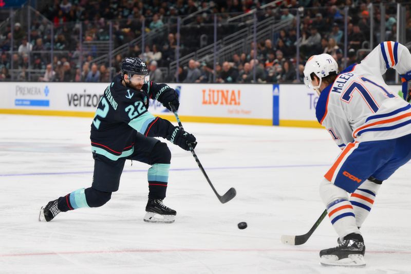 Mar 2, 2024; Seattle, Washington, USA; Seattle Kraken right wing Oliver Bjorkstrand (22) shoots the puck while defended by Edmonton Oilers center Ryan McLeod (71) during the second period at Climate Pledge Arena. Mandatory Credit: Steven Bisig-USA TODAY Sports