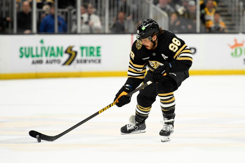 Mar 19, 2024; Boston, Massachusetts, USA;  Boston Bruins right wing David Pastrnak (88) controls the puck at center ice during the first period against the Ottawa Senators at TD Garden. Mandatory Credit: Bob DeChiara-USA TODAY Sports