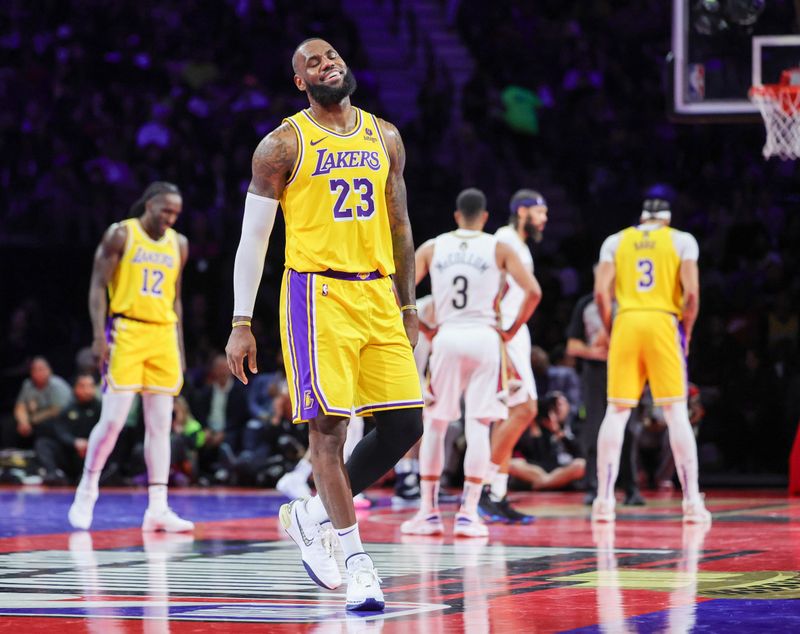 LAS VEGAS, NEVADA - DECEMBER 07: LeBron James #23 of the Los Angeles Lakers smiles as a teammate shoots a free throw against the New Orleans Pelicans in the second half of the West semifinal game of the inaugural NBA In-Season Tournament at T-Mobile Arena on December 07, 2023 in Las Vegas, Nevada. The Lakers defeated the Pelicans 133-89. NOTE TO USER: User expressly acknowledges and agrees that, by downloading and or using this photograph, User is consenting to the terms and conditions of the Getty Images License Agreement. (Photo by Ethan Miller/Getty Images)