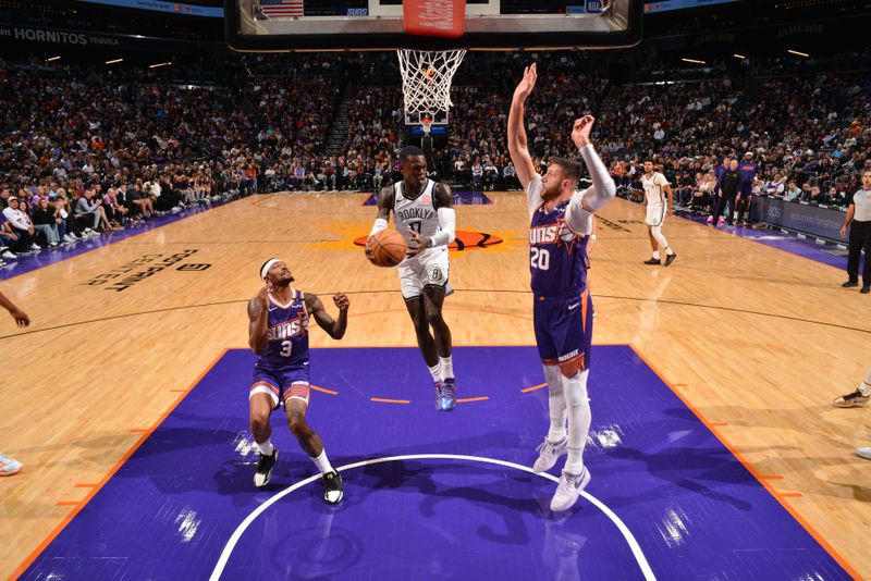 PHOENIX, AZ - NOVEMBER 27: Dennis Schroder #17 of the Brooklyn Nets looks to pass the ball during the game against the Phoenix Suns on November 27, 2024 at Footprint Center in Phoenix, Arizona. NOTE TO USER: User expressly acknowledges and agrees that, by downloading and or using this photograph, user is consenting to the terms and conditions of the Getty Images License Agreement. Mandatory Copyright Notice: Copyright 2024 NBAE (Photo by Barry Gossage/NBAE via Getty Images)