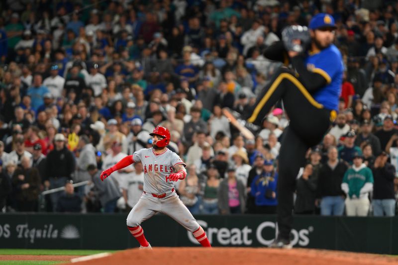 May 31, 2024; Seattle, Washington, USA; Los Angeles Angels right fielder Kevin Pillar (12) leads off first base while Seattle Mariners relief pitcher Andres Munoz (75) pitches during the ninth inning at T-Mobile Park. Mandatory Credit: Steven Bisig-USA TODAY Sports