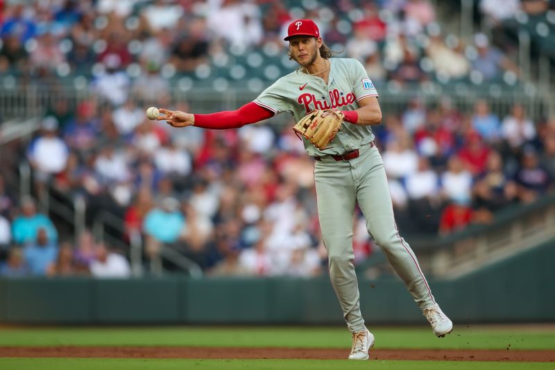 Aug 21, 2024; Atlanta, Georgia, USA; Philadelphia Phillies third baseman Alec Bohm (28) throws a runner out at first against the Atlanta Braves in the first inning at Truist Park. Mandatory Credit: Brett Davis-USA TODAY Sports