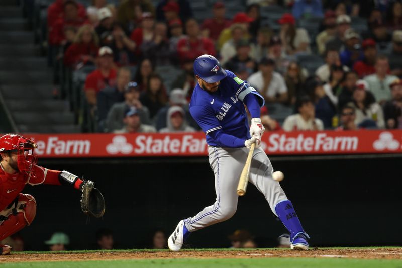 May 7, 2025; Anaheim, California, USA;  Toronto Blue Jays designated hitter Anthony Santander (25) hits an RBI single during the sixth inning against the Los Angeles Angels at Angel Stadium. Mandatory Credit: Kiyoshi Mio-Imagn Images