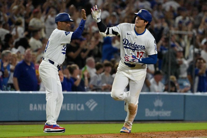Sep 16, 2025; Los Angeles, California, USA;  Los Angeles Dodgers designated hitter Shohei Ohtani (17) gets a high five from third base coach Dino Ebel (91) as he rounds the bases after hitting his 50th home run of the season during the eighth inning against the Philadelphia Phillies at Dodger Stadium. Mandatory Credit: Jayne Kamin-Oncea-Imagn Images