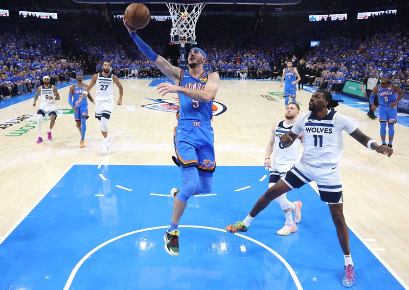 OKLAHOMA CITY, OKLAHOMA - MAY 22: Alex Caruso #9 of the Oklahoma City Thunder shoots the ball as Naz Reid #11 of the Minnesota Timberwolves looks on in Game Two of the Western Conference Finals of the 2025 NBA Playoffs at Paycom Center on May 22, 2025 in Oklahoma City, Oklahoma. NOTE TO USER: User expressly acknowledges and agrees that, by downloading and or using this photograph, User is consenting to the terms and conditions of the Getty Images License Agreement. (Photo by Matthew Stockman/Getty Images)