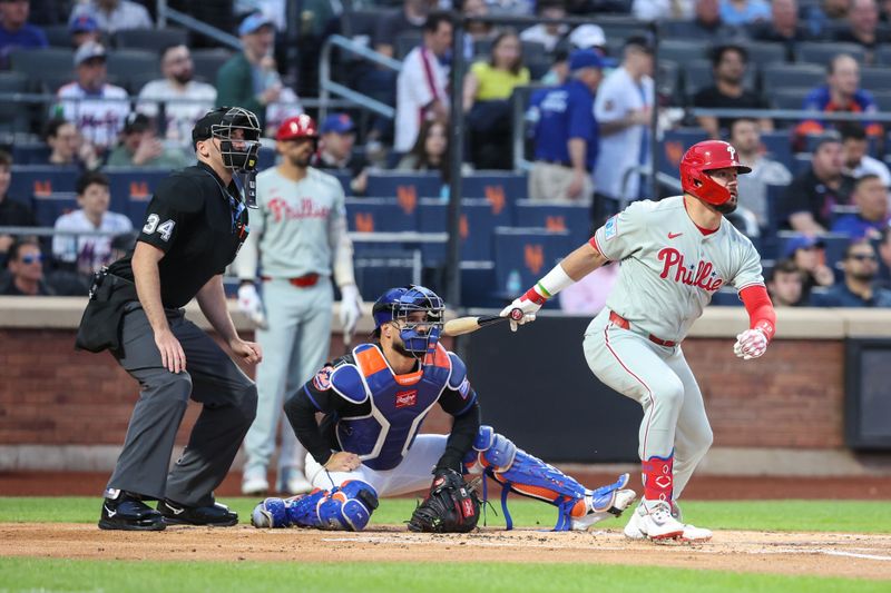 Apr 22, 2025; New York City, New York, USA;  Philadelphia Phillies designated hitter Kyle Schwarber (12) hits a single in the first inning against the New York Mets at Citi Field. Mandatory Credit: Wendell Cruz-Imagn Images