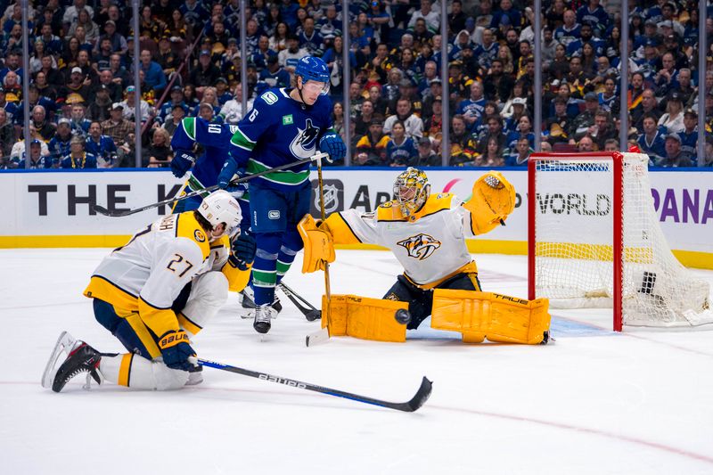 Apr 23, 2024; Vancouver, British Columbia, CAN; Vancouver Canucks forward Brock Boeser (6) and Nashville Predators goalie Juuse Saros (74) watch as defenseman Ryan McDonagh (27) blocks a shot during the third period in game two of the first round of the 2024 Stanley Cup Playoffs at Rogers Arena. Mandatory Credit: Bob Frid-USA TODAY Sports