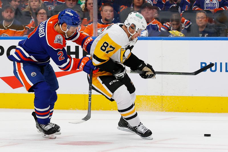 Oct 25, 2024; Edmonton, Alberta, CAN; Pittsburgh Penguins forward Sidney Crosby (87) protects the puck from Edmonton Oilers defensemen Evan Bouchard (2) during the second period at Rogers Place. Mandatory Credit: Perry Nelson-Imagn Images