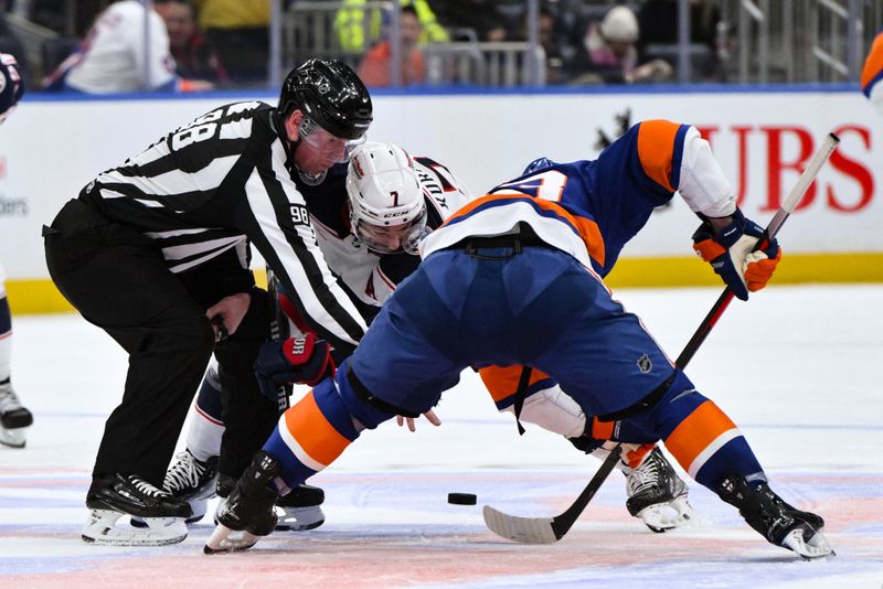 Dec 7, 2023; Elmont, New York, USA; Columbus Blue Jackets center Sean Kuraly (7) faces off against New York Islanders center Casey Cizikas (53) during the third period at UBS Arena. Mandatory Credit: John Jones-USA TODAY Sports