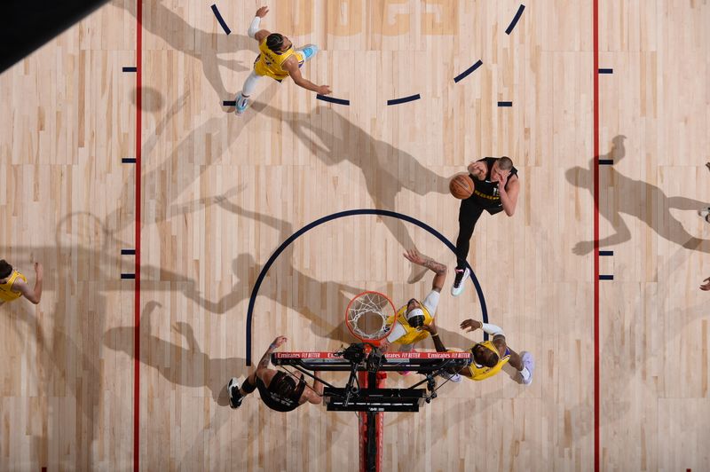 DENVER, CO - APRIL 22: Nikola Jokic #15 of the Denver Nuggets drives to the basket during the game against the Los Angeles Lakers on April 22, 2024 at the Ball Arena in Denver, Colorado. NOTE TO USER: User expressly acknowledges and agrees that, by downloading and/or using this Photograph, user is consenting to the terms and conditions of the Getty Images License Agreement. Mandatory Copyright Notice: Copyright 2024 NBAE (Photo by Bart Young/NBAE via Getty Images)