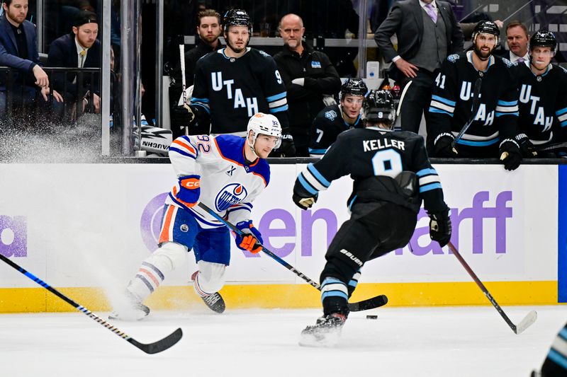 Nov 29, 2024; Salt Lake City, Utah, USA; Edmonton Oilers right wing Vasily Podkolzin (92) passes the puck past Utah Hockey Club center Clayton Keller (9) during the third period at the Delta Center. Mandatory Credit: Christopher Creveling-Imagn Images