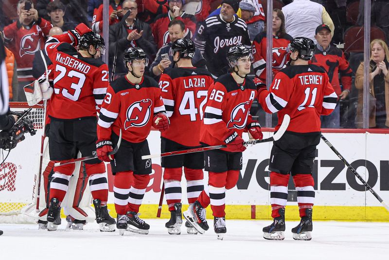 Mar 7, 2024; Newark, New Jersey, USA; New Jersey Devils goaltender Nico Daws (50) and defenseman Kurtis MacDermid (23) celebrate after defeating the St. Louis Blues at Prudential Center. Mandatory Credit: Vincent Carchietta-USA TODAY Sports