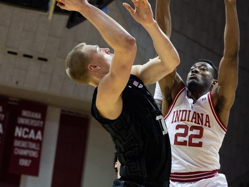 Jan 22, 2023; Bloomington, Indiana, USA; Michigan State Spartans forward Joey Hauser (10) shoots the ball while Indiana Hoosiers forward Jordan Geronimo (22) defends in the second half at Simon Skjodt Assembly Hall. Mandatory Credit: Trevor Ruszkowski-USA TODAY Sports