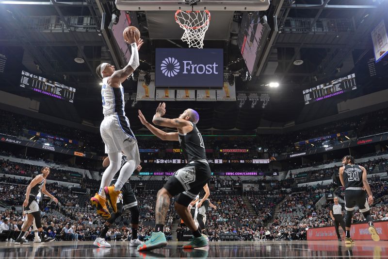 SAN ANTONIO, TX - MARCH 14: Paolo Banchero #5 of the Orlando Magic drives to the basket during the game against the San Antonio Spurs on March 14, 2023 at the AT&T Center in San Antonio, Texas. NOTE TO USER: User expressly acknowledges and agrees that, by downloading and or using this photograph, user is consenting to the terms and conditions of the Getty Images License Agreement. Mandatory Copyright Notice: Copyright 2023 NBAE (Photos by Michael Gonzales/NBAE via Getty Images)