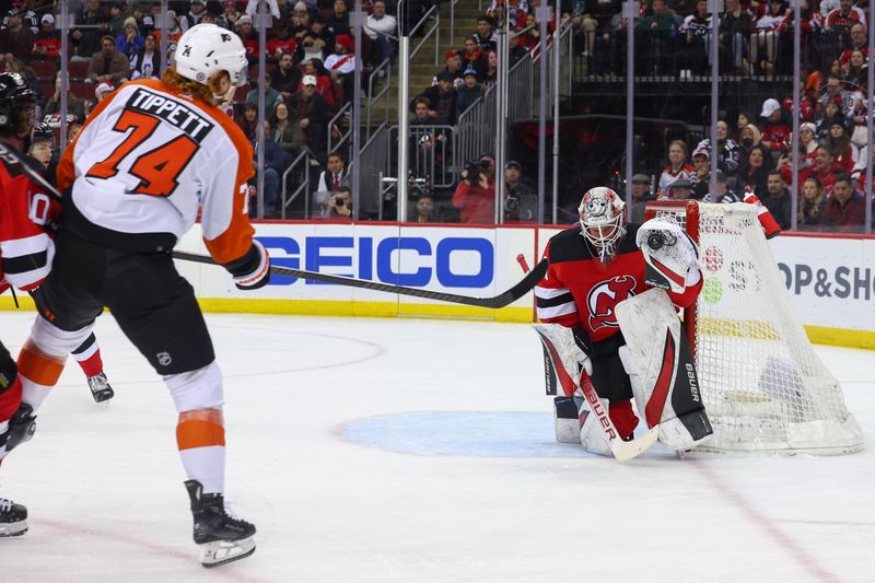 Dec 19, 2023; Newark, New Jersey, USA; New Jersey Devils goaltender Vitek Vanecek (41) makes a save on Philadelphia Flyers right wing Owen Tippett (74) during the first period at Prudential Center. Mandatory Credit: Ed Mulholland-USA TODAY Sports