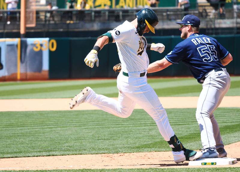 Jun 15, 2023; Oakland, California, USA; Tampa Bay Rays first baseman Luke Raley (55) catches the ball for a double play against Oakland Athletics designated hitter Seth Brown (15) during the seventh inning at Oakland-Alameda County Coliseum. Mandatory Credit: Kelley L Cox-USA TODAY Sports