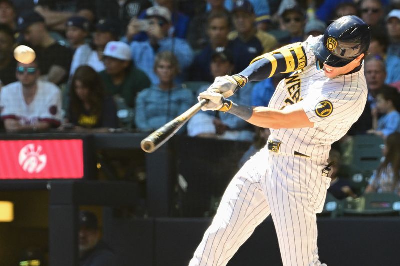 Jun 30, 2024; Milwaukee, Wisconsin, USA; Milwaukee Brewers left fielder Christian Yelich (22) hits a 2-run home run in the fourth inning against the Chicago Cubs at American Family Field. Mandatory Credit: Benny Sieu-USA TODAY Sports