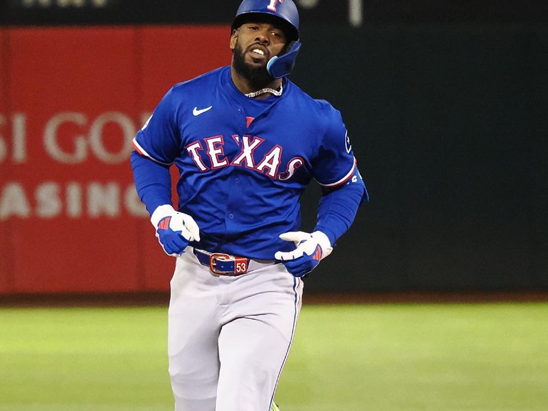 Sep 25, 2024; Oakland, California, USA; Texas Rangers right fielder Adolis Garcia (53) rounds the bases on a two-run home run against the Oakland Athletics during the third inning at Oakland-Alameda County Coliseum. Mandatory Credit: Kelley L Cox-Imagn Images