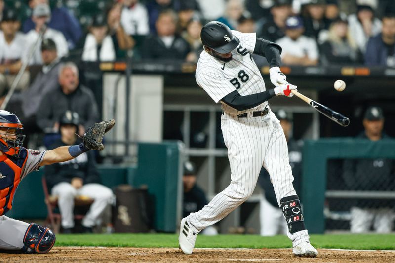 May 13, 2023; Chicago, Illinois, USA; Chicago White Sox center fielder Luis Robert Jr. (88) hits an RBI-single against the Houston Astros during the eighth inning at Guaranteed Rate Field. Mandatory Credit: Kamil Krzaczynski-USA TODAY Sports