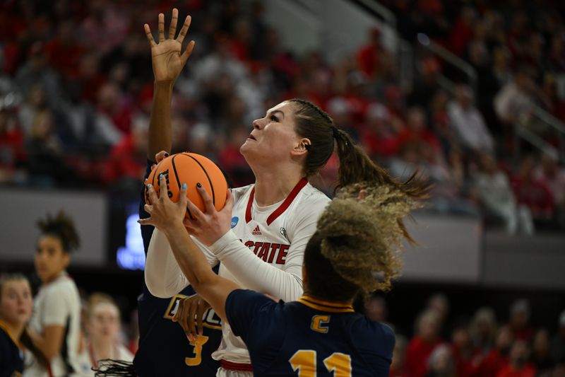 Mar 23, 2024; Raleigh, North Carolina, USA; NC State Wolfpack center River Baldwin (1) shoots between Chattanooga Lady Mocs forward Takia Davis (3) and guard Caia Elisaldez (11) in the first round of the 2024 NCAA Women's Tournament at James T. Valvano Arena at William Neal Reynolds. Mandatory Credit: William Howard-USA TODAY Sports