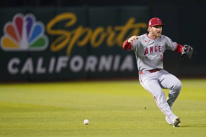 Jul 19, 2024; Oakland, California, USA; Los Angeles Angels left fielder Taylor Ward (3) commits an error against the Oakland Athletics in the sixth inning at Oakland-Alameda County Coliseum. Mandatory Credit: Cary Edmondson-USA TODAY Sports