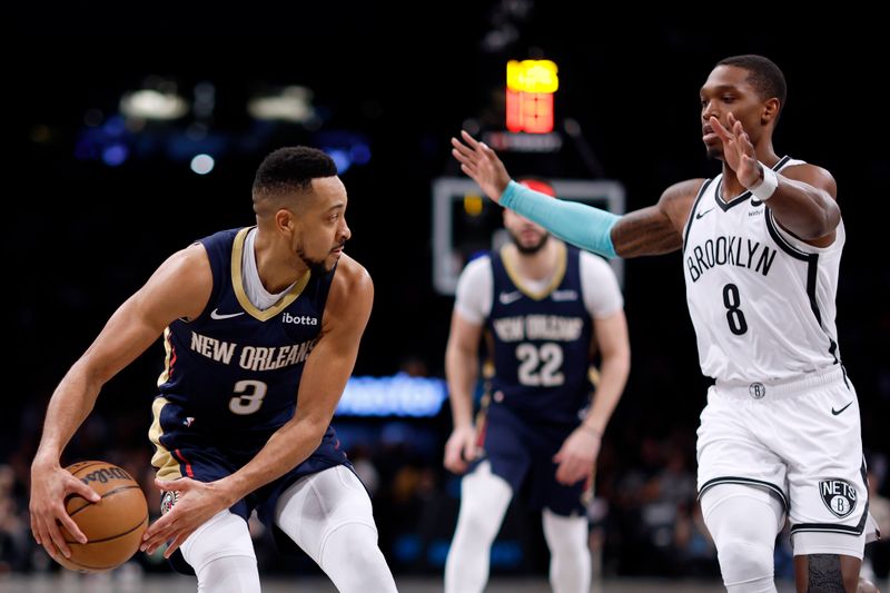 NEW YORK, NEW YORK - MARCH 19: CJ McCollum #3 of the New Orleans Pelicans looks to pass as Lonnie Walker IV #8 of the Brooklyn Nets defends during the first half at Barclays Center on March 19, 2024 in the Brooklyn borough of New York City. NOTE TO USER: User expressly acknowledges and agrees that, by downloading and/or using this Photograph, user is consenting to the terms and conditions of the Getty Images License Agreement. (Photo by Sarah Stier/Getty Images)