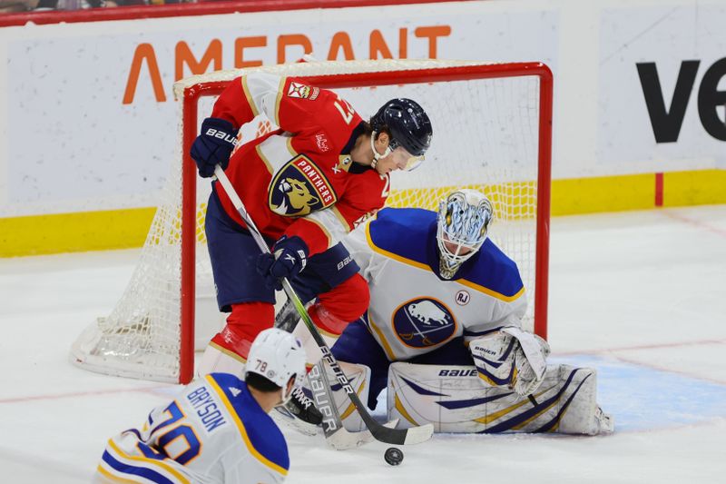 Apr 13, 2024; Sunrise, Florida, USA; Florida Panthers center Eetu Luostarinen (27) controls the puck against Buffalo Sabres goaltender Ukko-Pekka Luukkonen (1) during the third period at Amerant Bank Arena. Mandatory Credit: Sam Navarro-USA TODAY Sports