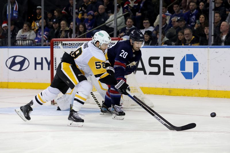 Dec 6, 2024; New York, New York, USA; Pittsburgh Penguins defenseman Kris Letang (58) and New York Rangers left wing Chris Kreider (20) fight for the puck during the third period at Madison Square Garden. Mandatory Credit: Brad Penner-Imagn Images