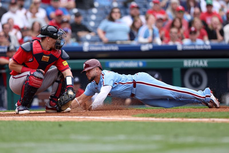May 29, 2025; Philadelphia, Pennsylvania, USA; Philadelphia Phillies catcher Rafael Marchán (13) scores past the tag attempt of Atlanta Braves catcher Sean Murphy (12) during the fifth inning at Citizens Bank Park. Mandatory Credit: Bill Streicher-Imagn Images