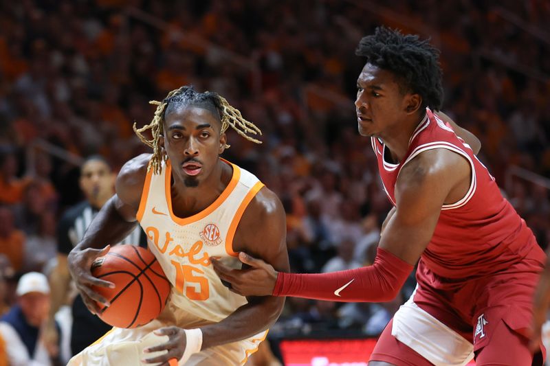 Jan 4, 2025; Knoxville, Tennessee, USA; Tennessee Volunteers guard Jahmai Mashack (15) moves the ball against Arkansas Razorbacks forward Karter Knox (11) during the first half at Thompson-Boling Arena at Food City Center. Mandatory Credit: Randy Sartin-Imagn Images