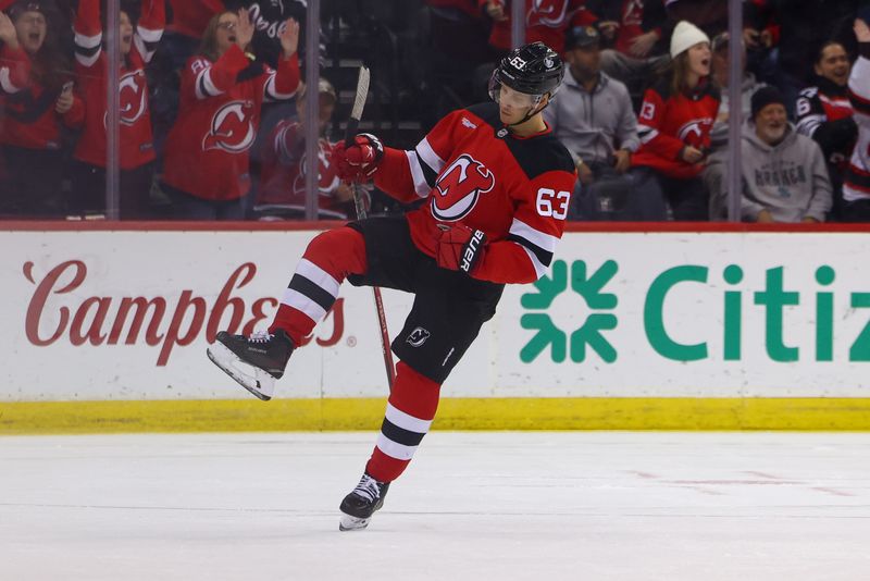 Nov 21, 2024; Newark, New Jersey, USA; New Jersey Devils left wing Jesper Bratt (63) celebrates his goal against the Carolina Hurricanes during the third period at Prudential Center. Mandatory Credit: Ed Mulholland-Imagn Images