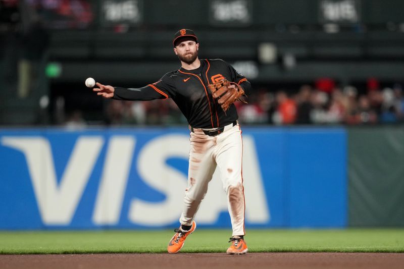 Sep 13, 2025; San Francisco, California, USA; San Francisco Giants second baseman Casey Schmitt (10) throws the ball to first to record an out against the Los Angeles Dodgers in the seventh inning at Oracle Park. Mandatory Credit: Cary Edmondson-Imagn Images