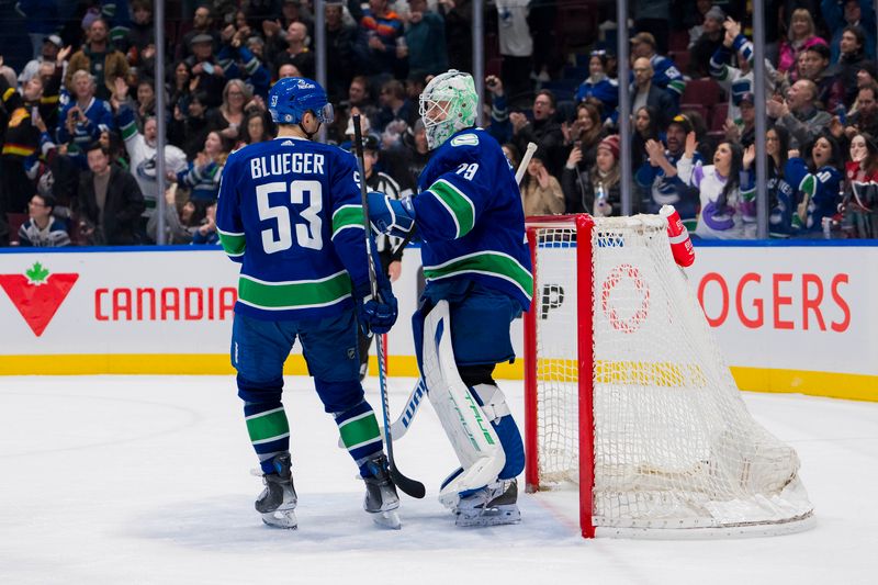 Mar 9, 2024; Vancouver, British Columbia, CAN; Vancouver Canucks forward Teddy Blueger (53) and goalie Casey DeSmith (29) celebrate their victory against the Winnipeg Jets at Rogers Arena. Canucks won 5-0. Mandatory Credit: Bob Frid-USA TODAY Sports