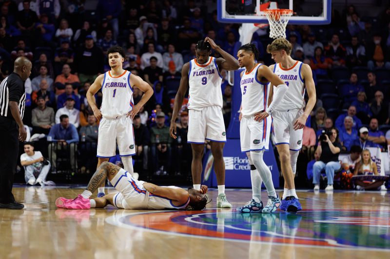 Jan 14, 2025; Gainesville, Florida, USA; Florida Gators guard Alijah Martin (15) lays on the floor while Florida Gators guard Walter Clayton Jr. (1), Florida Gators center Rueben Chinyelu (9), Florida Gators guard Will Richard (5) and Florida Gators forward Thomas Haugh (10) watch against the Missouri Tigers during the second half at Exactech Arena at the Stephen C. O'Connell Center. Mandatory Credit: Matt Pendleton-Imagn Images